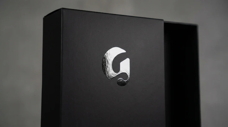 Spot UV glossy logo finish on matte black custom packaging box showing sheen contrast